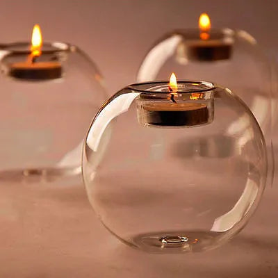 Hand-blown Europe style hollow glass candle holder in round design on table