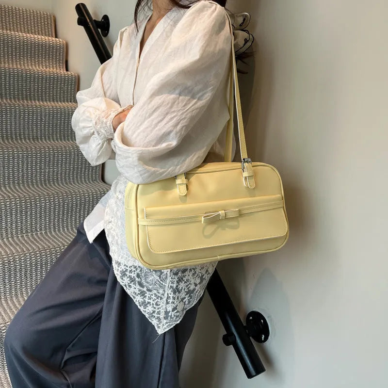 Single-shoulder flap bag in PU leather with bow stitching details and horizontal square shape