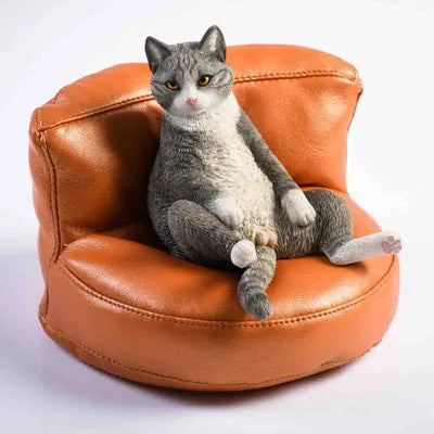 Lazy cat model ornament with sofa on car dashboard, 7.5cm high resin decoration.