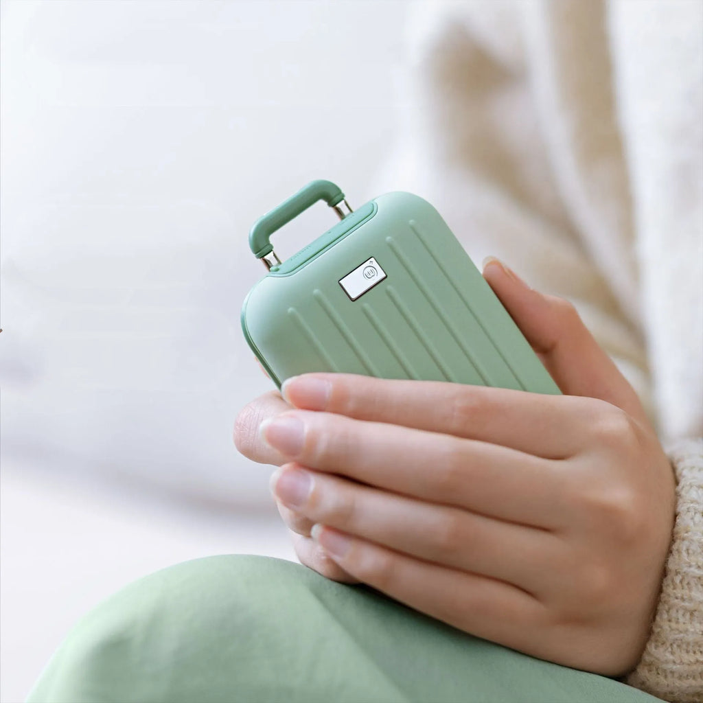 Travel box hand warmer in dark blue with aluminium alloy body showing double-sided heating surface