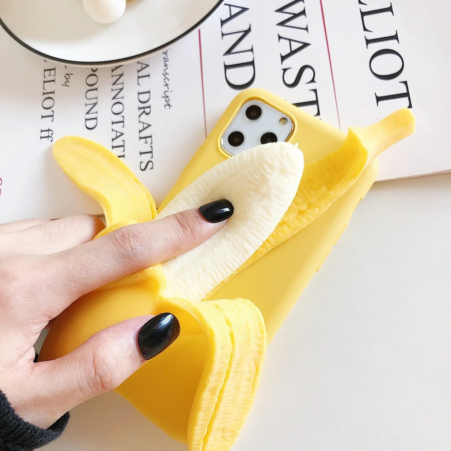 Creative Personality Squeeze The Banana design on a yellow hard back cover for an iPhone.