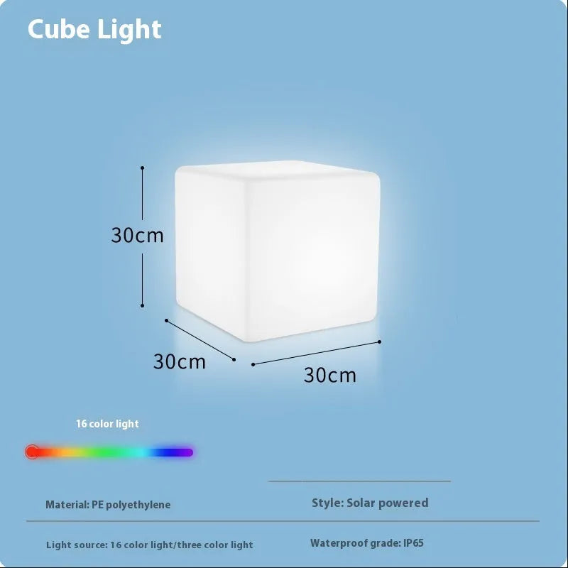 Modern white LED cube stool light outdoors, showing flat top and clean design.