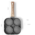 Non-stick four-hole frying pan with medical stone coating on a gas hob cooking eggs and pancakes