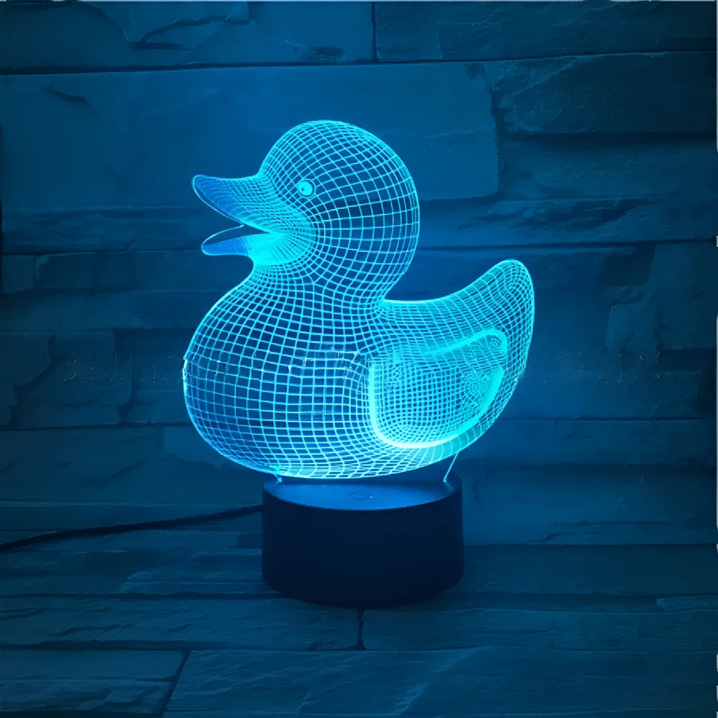 Yellow duck cartoon 3D night light table lamp with remote control on a table.