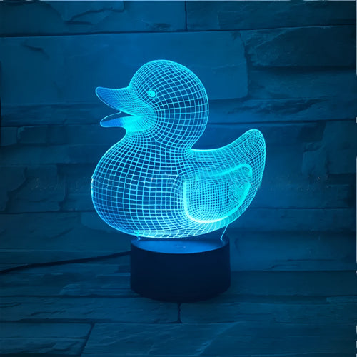 Yellow duck cartoon 3D night light table lamp with remote control on a table.