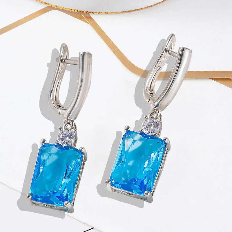 Square geometric earrings with electroplated gold or silver finish on copper, showing quadrilateral design elements