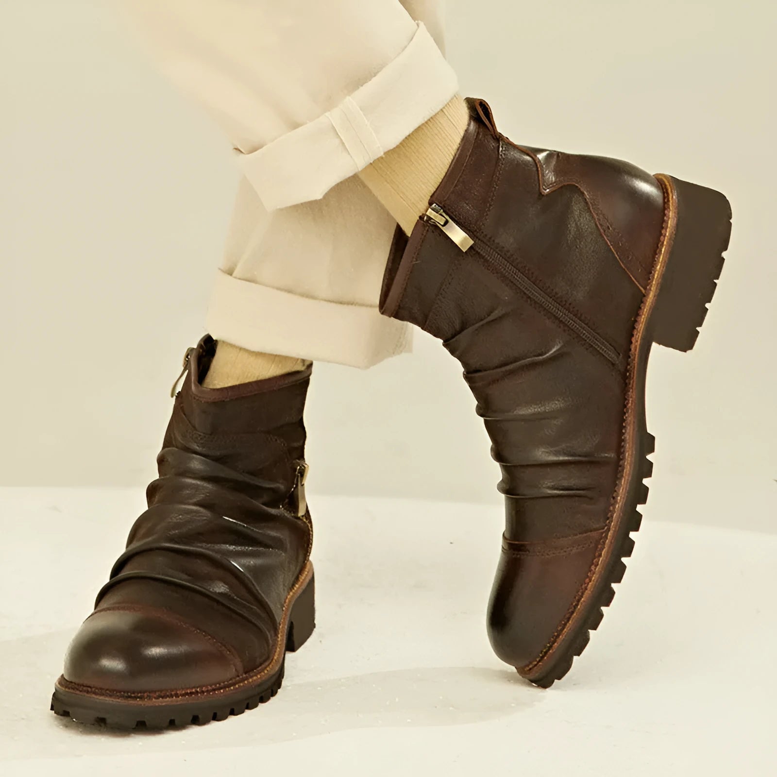 Black cowboy boots with side zip closure, embossed PU uppers, and horseshoe heel on wooden floor