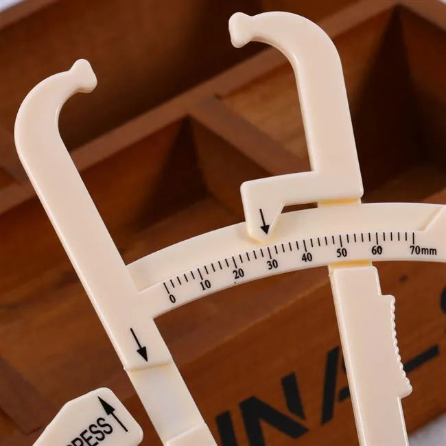 Clear acrylic body fat caliper with measurement scale showing 200mm range and 0.001mm accuracy.