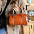 Cortex Lady casual zip crossbody bag in top grain leather, cylindrical shape, patchwork, available in caramel colour