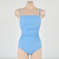 Blue sling style one-piece swimsuit with belly pleats on a mannequin, showing slim-fit design