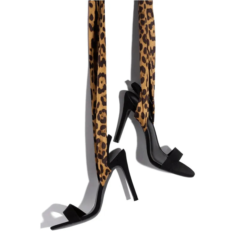 Light brown leopard print women's high heel sandals with cross straps and a fine heel.