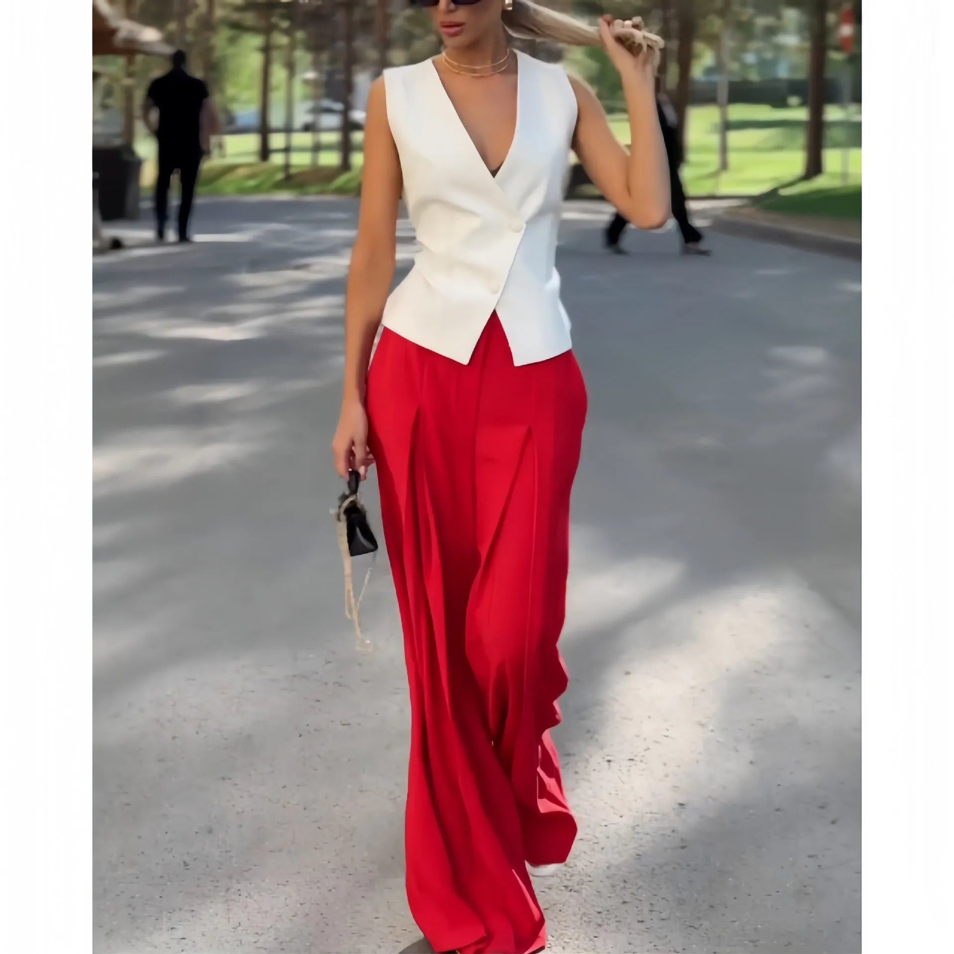 Women's beige two-piece set with deep V-neck sleeveless top and high-waisted wide leg trousers.