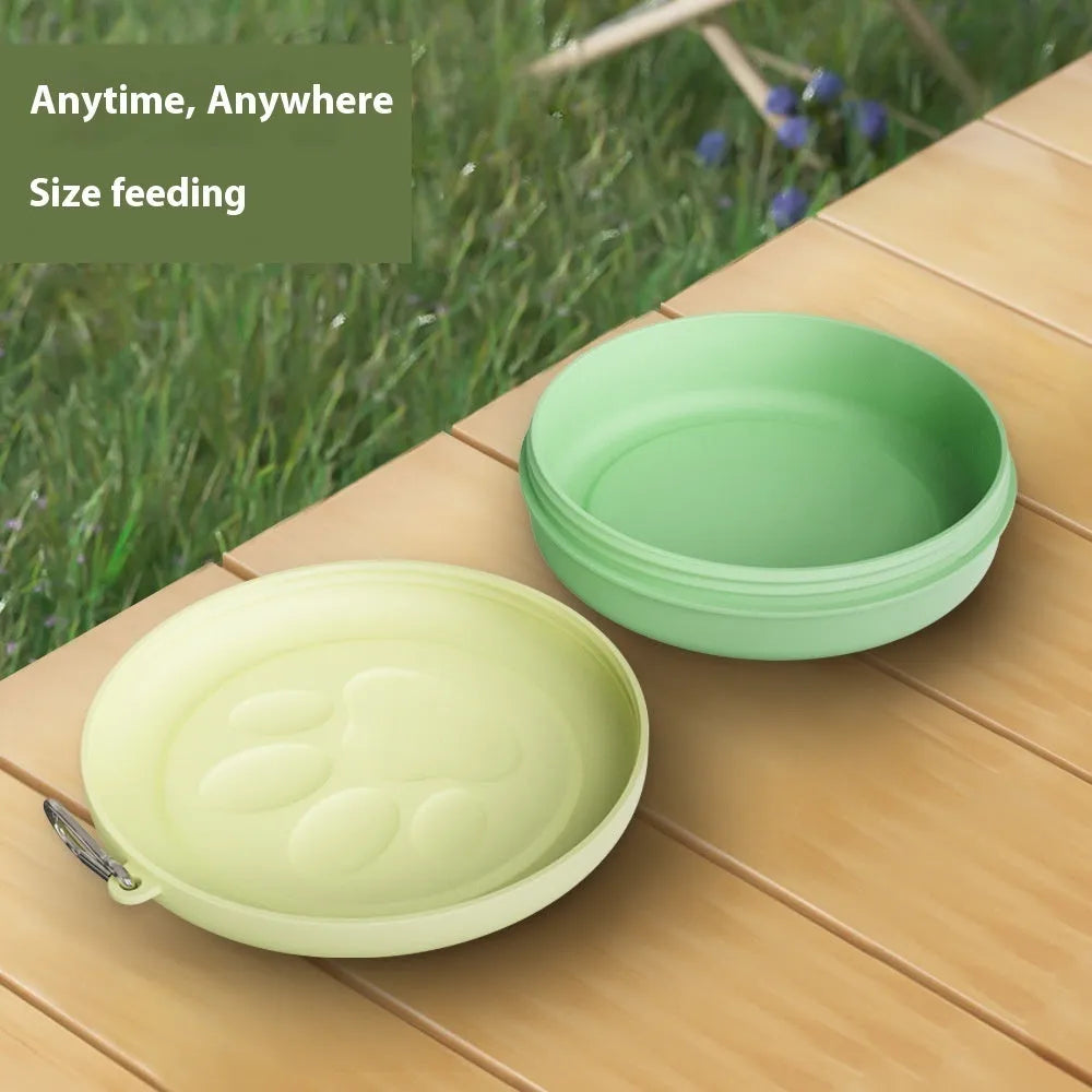 Portable plastic dog bowl for outdoor feeding and water, shown in two-tone green colour.