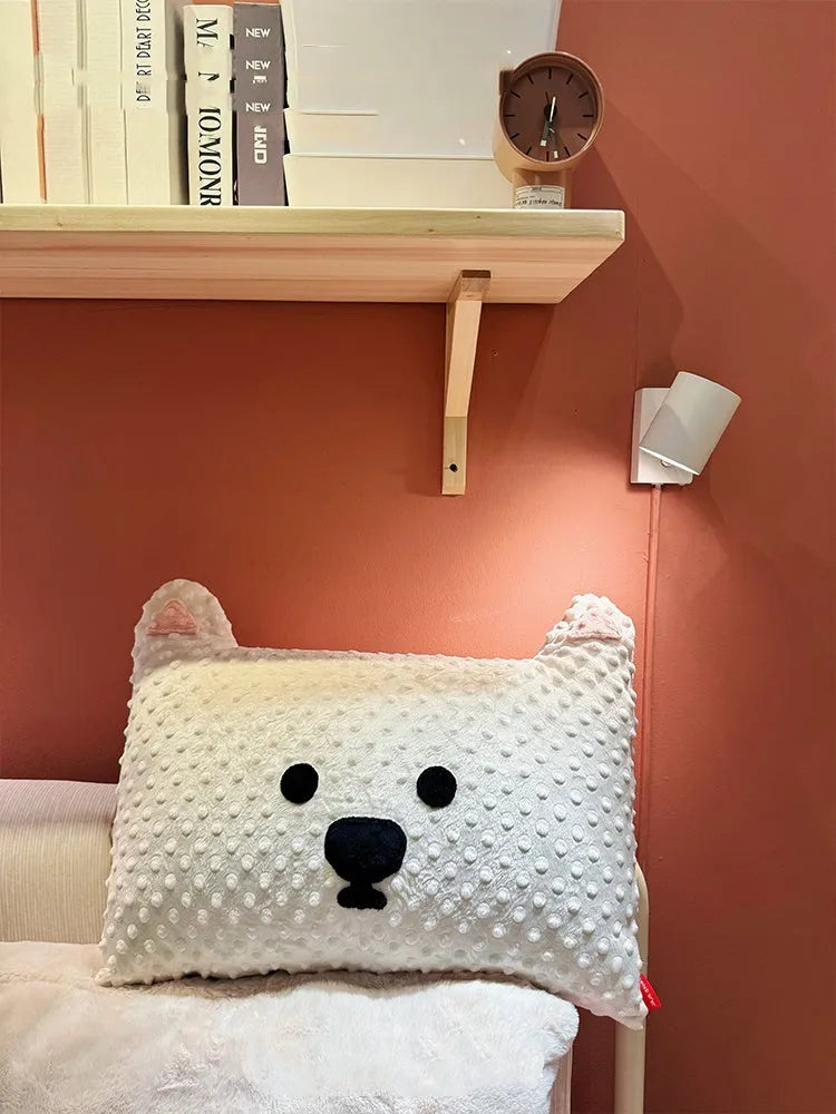 Grey schnauzer and white West Highland puppy decorative cushion pillow on a sofa.