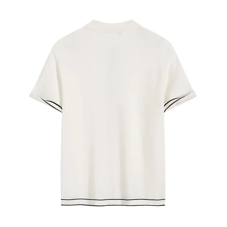 White cardigan with dark contrast lapels and short sleeves, laid flat.