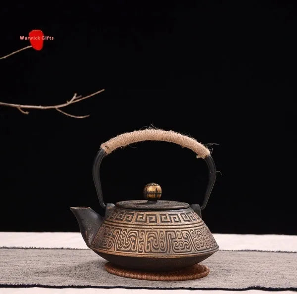 Japanese cast iron teapot in black with Peony pattern, showing lid, handle, and spout.