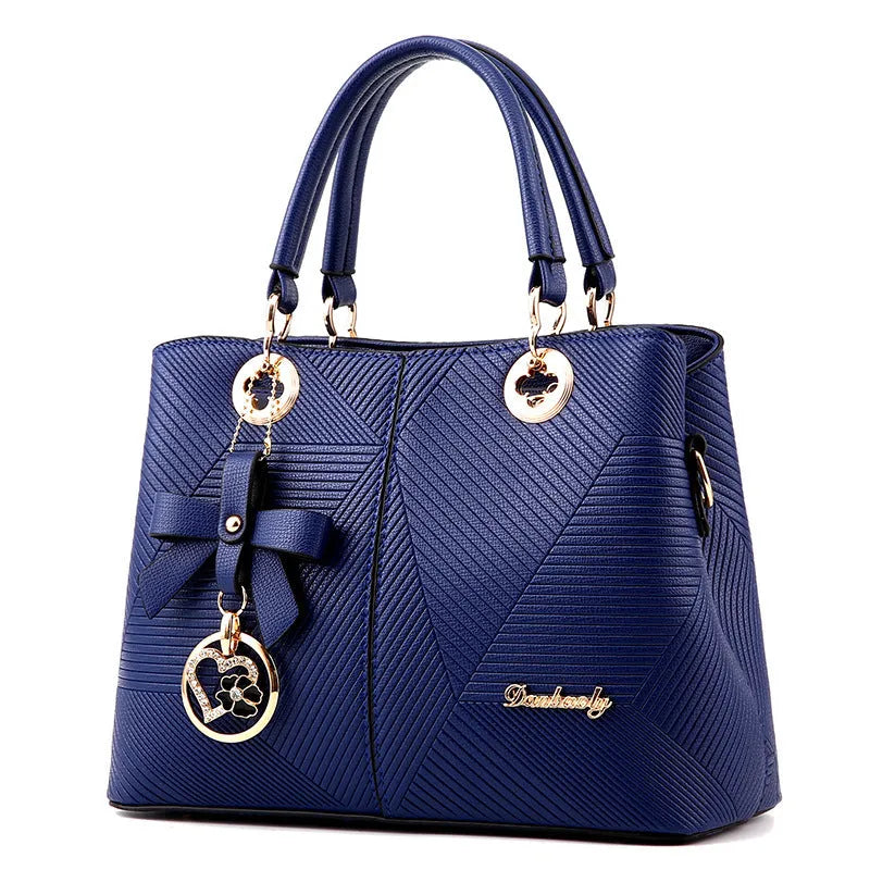 Retro PU handbag in black with silver zip and shoulder strap.