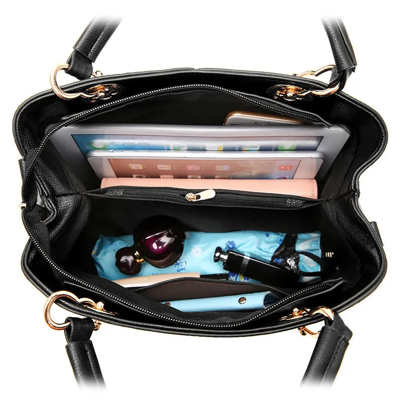 Retro PU handbag in black with silver zip and shoulder strap.