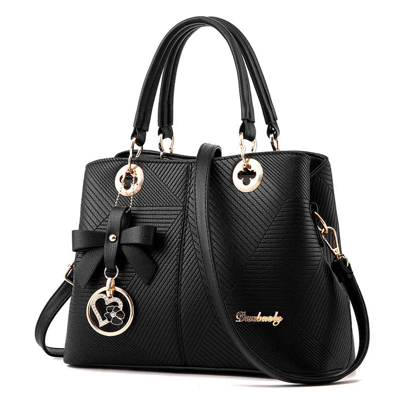 Retro PU handbag in black with silver zip and shoulder strap.