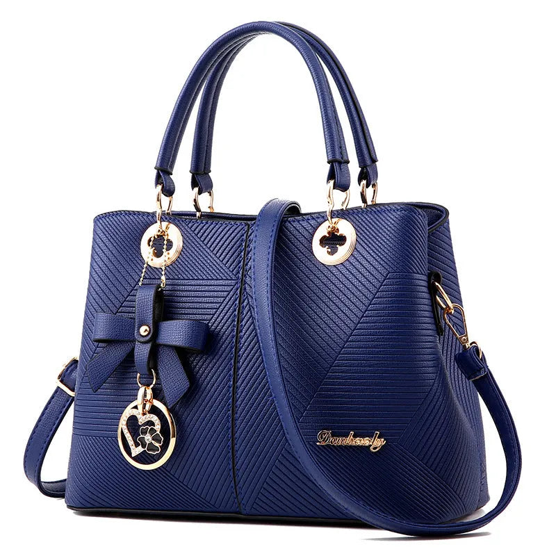 Retro PU handbag in black with silver zip and shoulder strap.