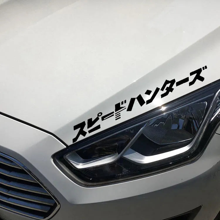 Black and white reflective Japanese car sticker measuring 35x35cm on a vehicle window.