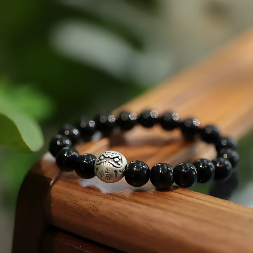 Natural black agate beaded bracelet with sterling silver clasp showing Chinese style threading