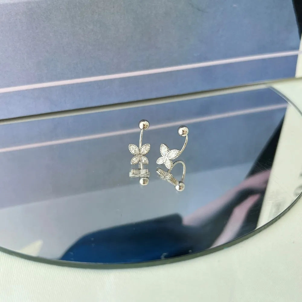 Pair of S925 silver bow-shaped ear hook earrings in gold finish on simple background