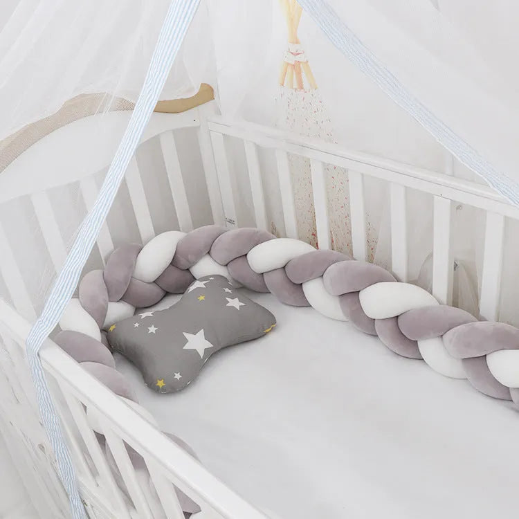 Multi-colour baby crib bumper made of spandex velvet, shown bent around a crib edge.