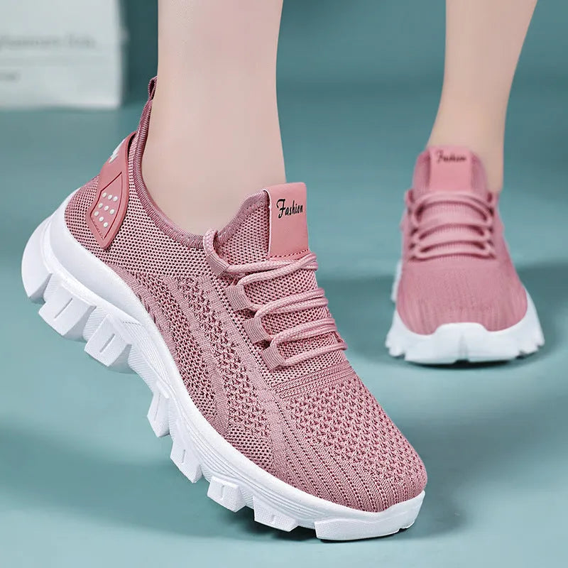Women's white Flyknit sneakers with round toe and flat heel on a thick PVC sole.