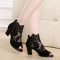 Women's black lace gladiator sandals with square heel, floral pattern, and peep toe design