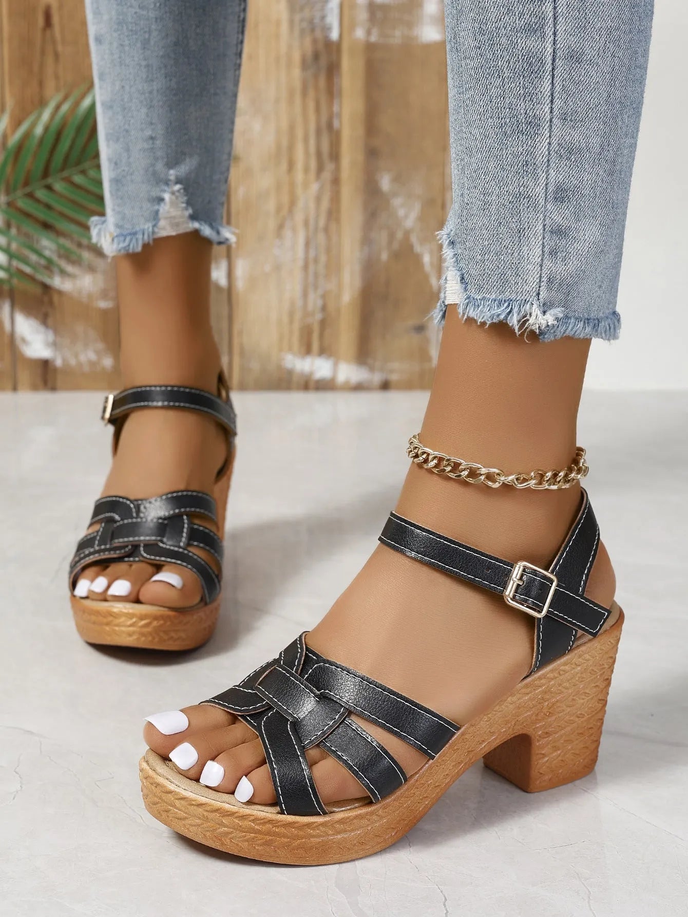 Plus size women's black peep toe sandals with a chunky heel and buckle ankle strap