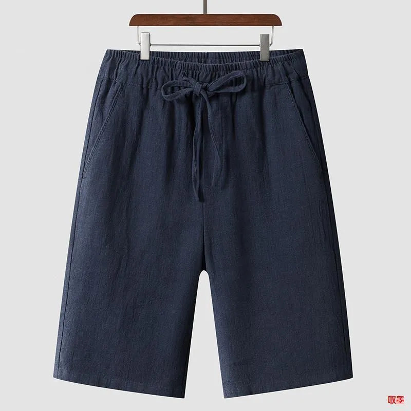 Men's loose-fit linen shorts in a cropped mid-length style with an elastic waistband.