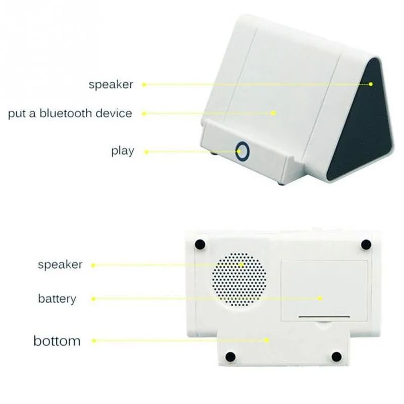 Compact black and white wireless Bluetooth mini speaker with charging cable.