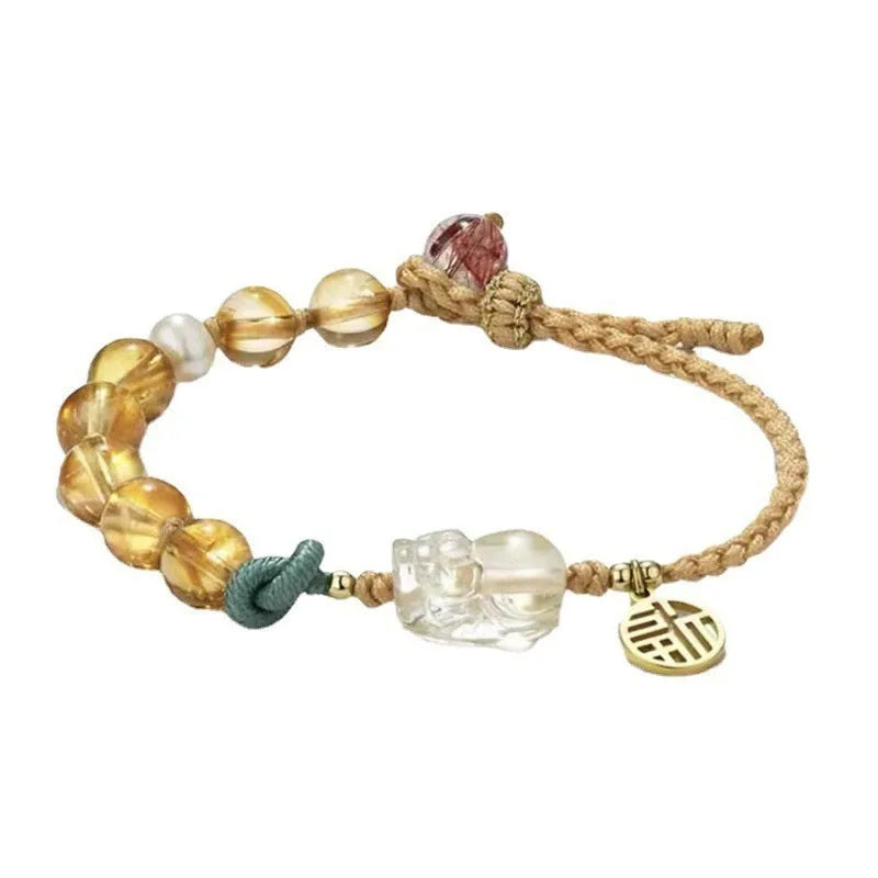 Hand-woven citrine crystal bracelet with zodiac animal design on wrist