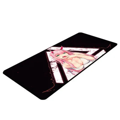 Pink cloth keyboard mat with Darling in the Franxx anime print on a desk