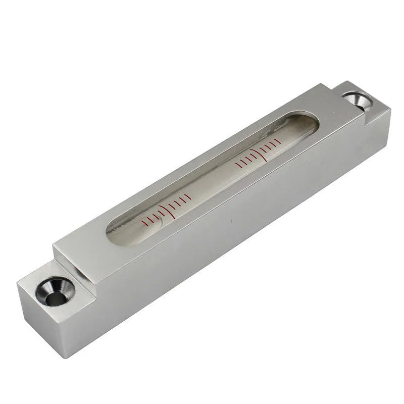 Mini metal and glass spirit level showing dual accuracy scales for precise measurement