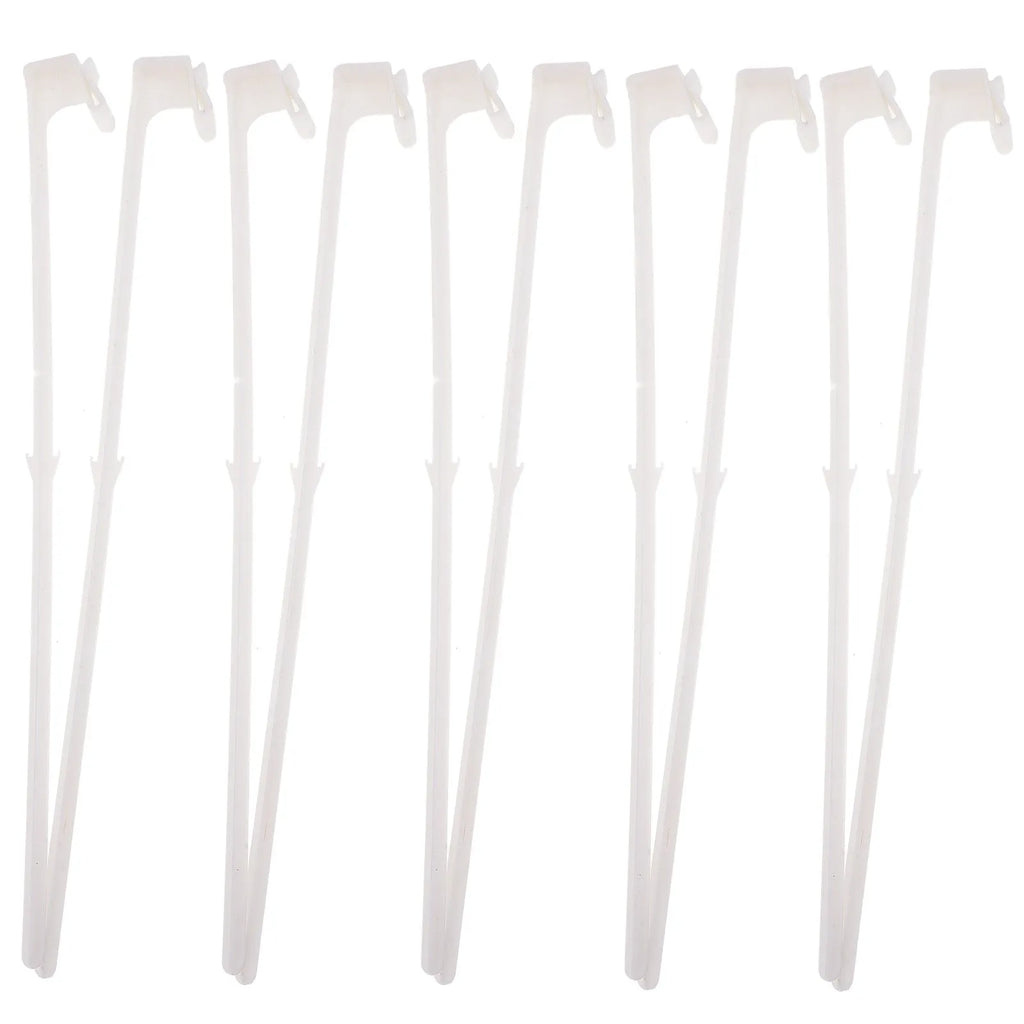 Ten white plastic car window flag pole holder clips laid out.