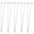 Ten white plastic car window flag pole holder clips laid out.