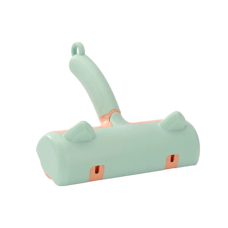Mint green manual brush for removing cat hair from furniture and fabrics, showing its size.