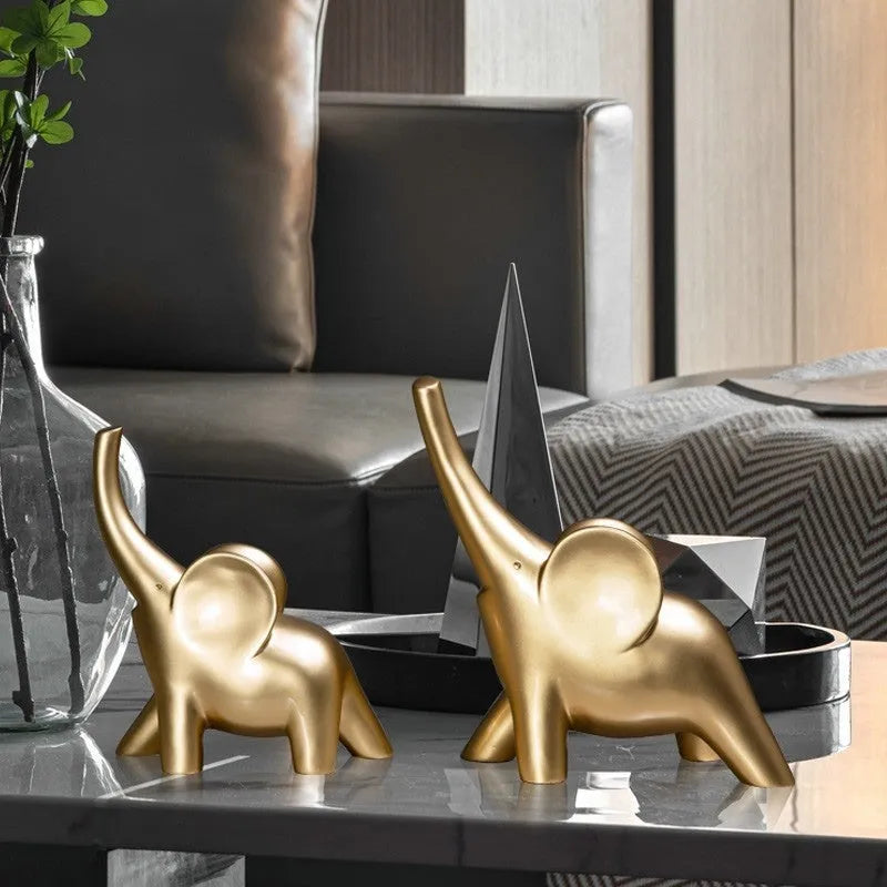 Modern minimalist solid resin elephant ornament in rose gold or white finish on a shelf.