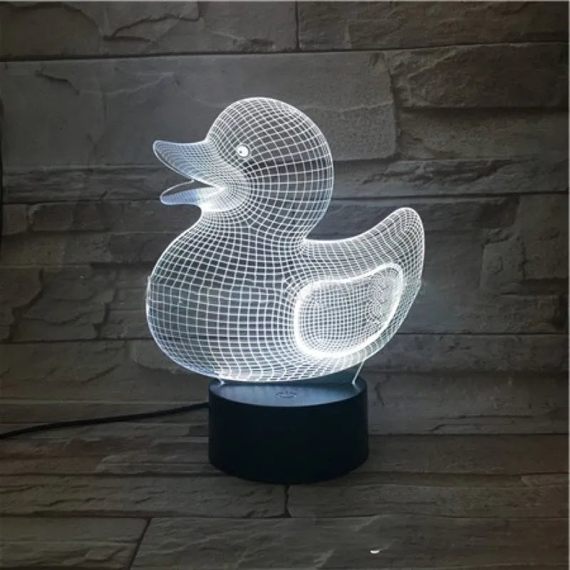 Yellow duck cartoon 3D night light table lamp with remote control on a table.