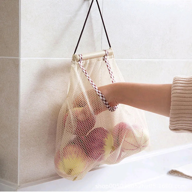 Beige plaid polyester mesh kitchen storage bag with cotton rope loops on a wall hook, 26x29cm
