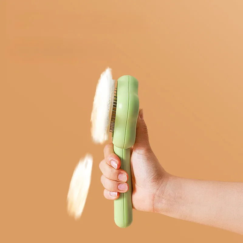 Green self-cleaning cat comb with stainless steel needles and retraction button