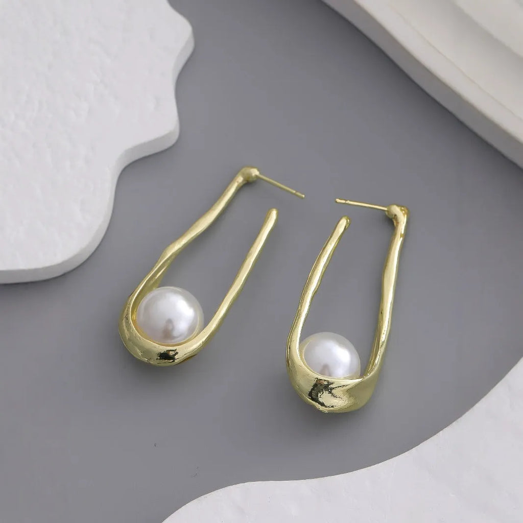 Gold-tone hook earrings with an irregular natural pearl in a vintage European style