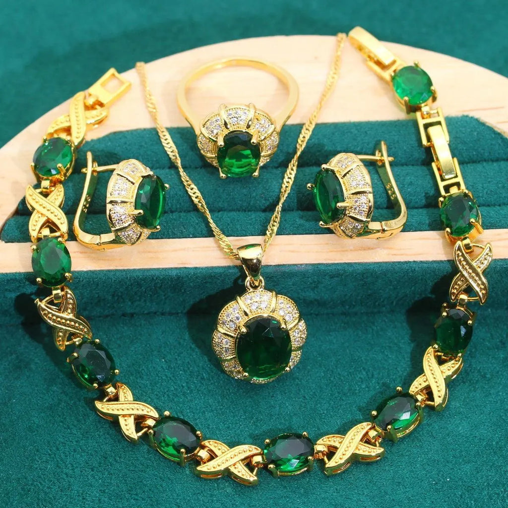 Gold-coloured jewellery set with coloured cubic zirconia stones, showing necklace, earrings, ring, and bracelet.