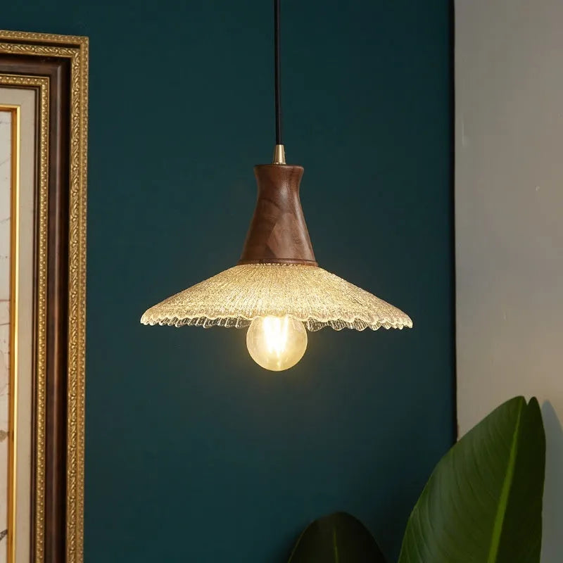 Wood and brass ceiling chandelier with glass lampshade in three available sizes.