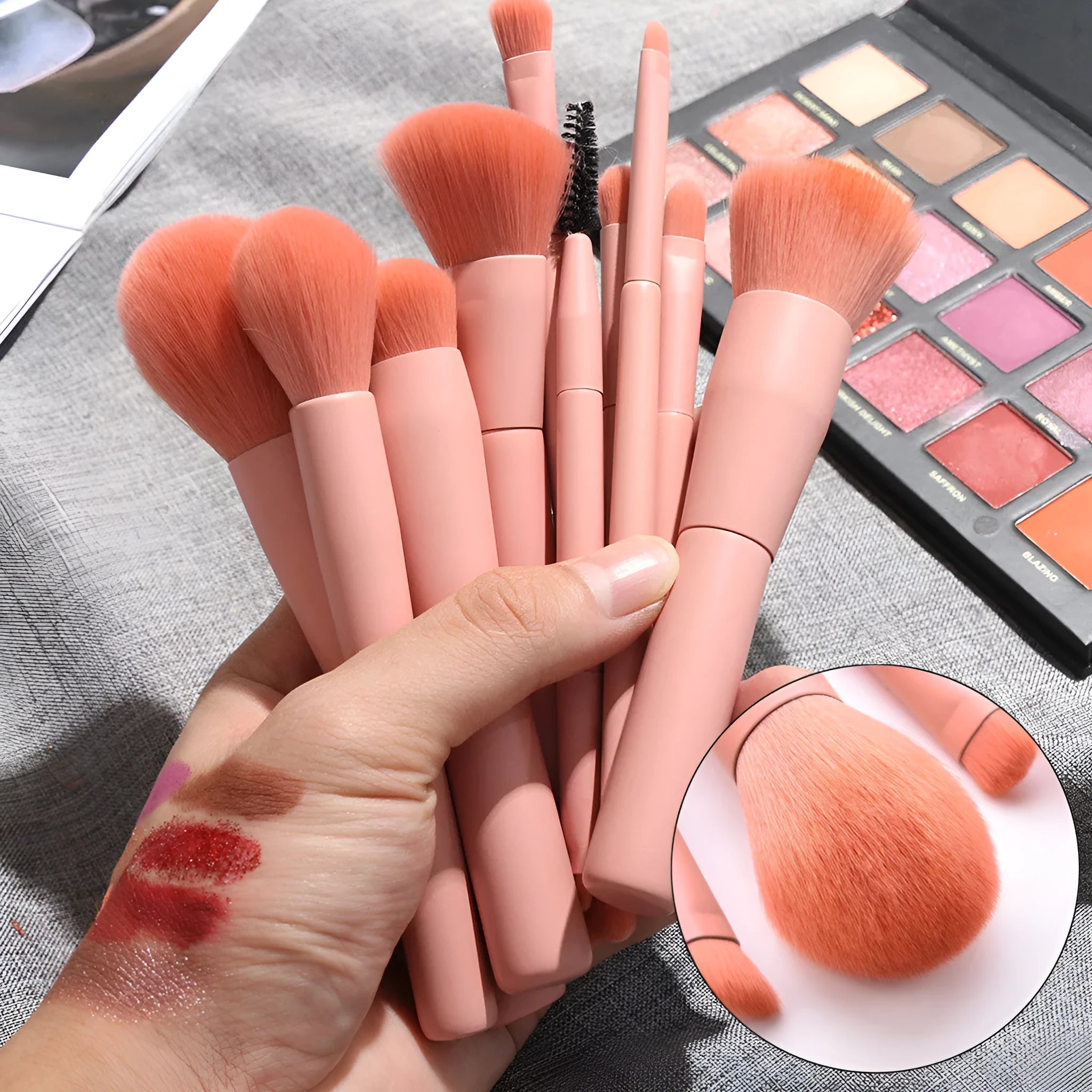 Ten professional makeup brushes with wooden handles arranged by size for different cosmetic applications