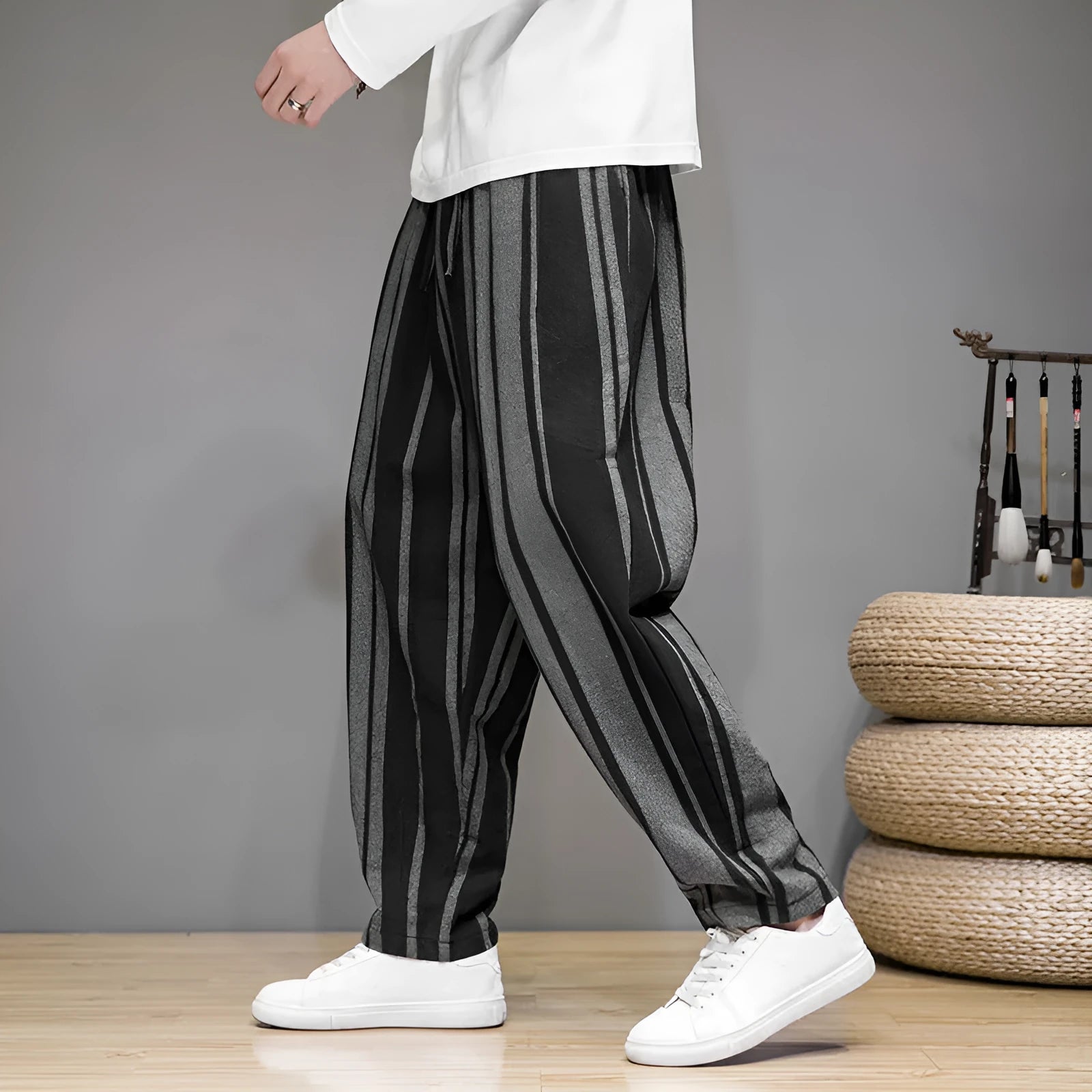 Men's navy blue and black striped wide-leg casual trousers with mid waist, laid flat.