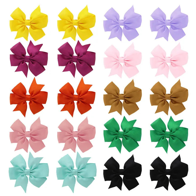 Assorted colourful handmade grosgrain ribbon pinwheel hair bows with alligator clips for toddlers.