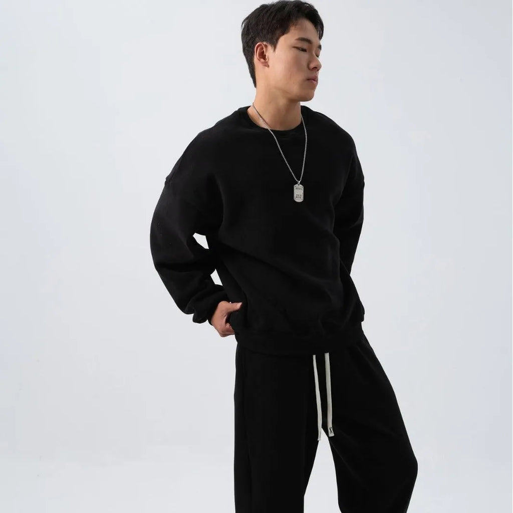 Men's polar fleece tracksuit set showing crew neck top with padded trousers in winter sportswear style